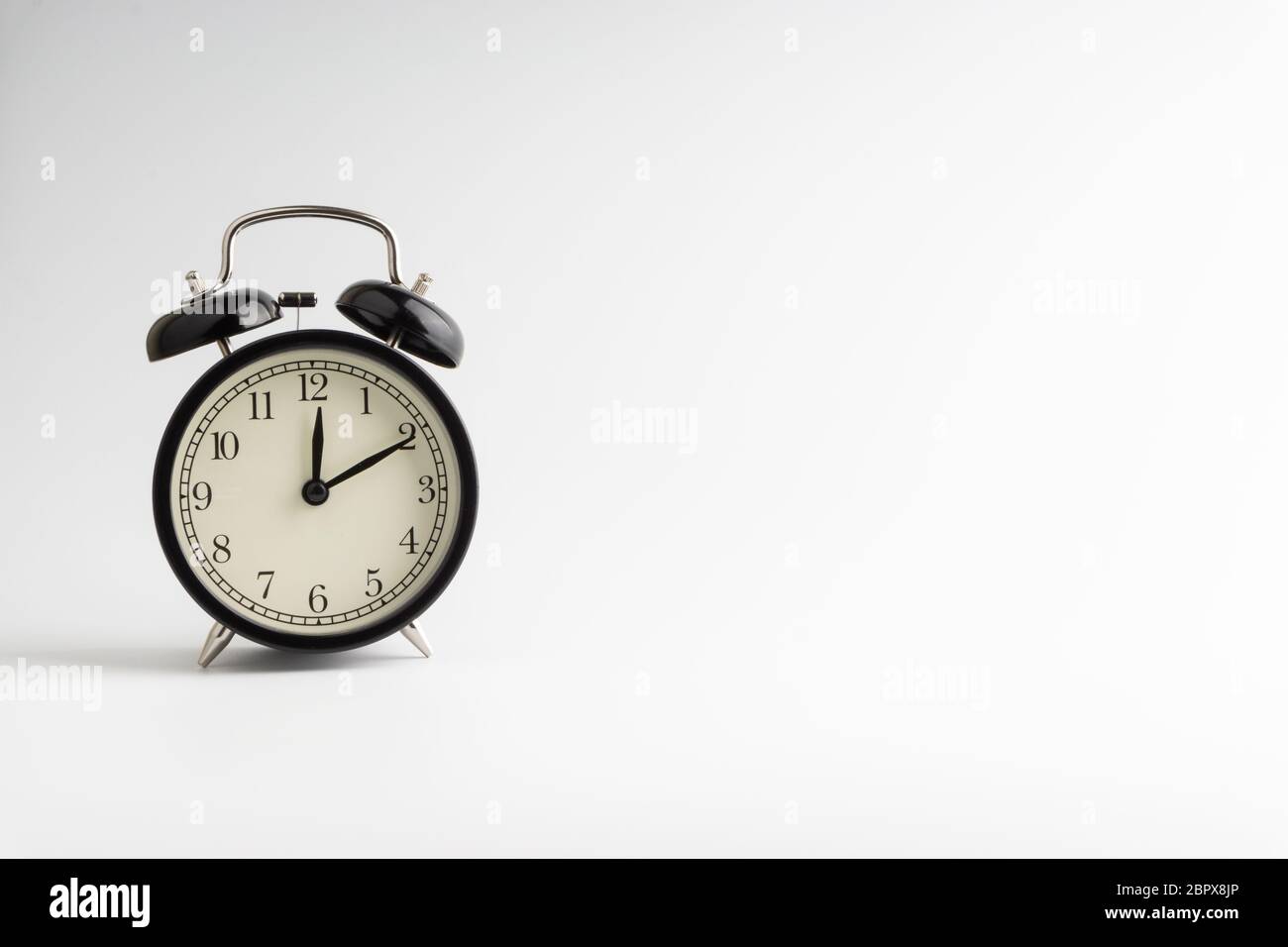 Alarm Clock on white background with selective focus and crop fragment ...