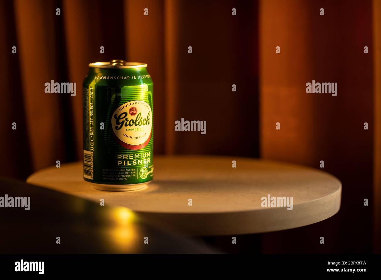Eindhoven, The Netherlands, April 10th 2020. A can of Dutch Grolsch beer on a old wooden table