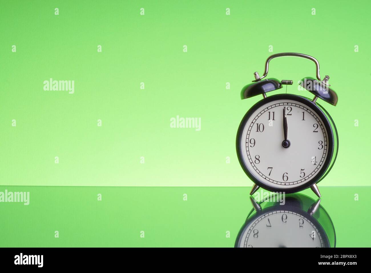 Alarm Clock on green background with selective focus and crop fragment ...