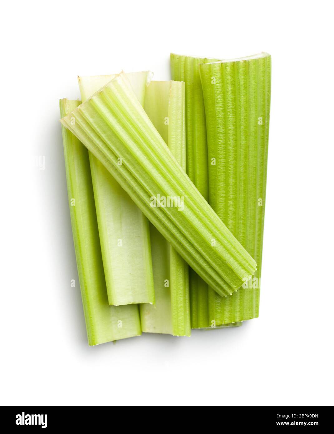 Celery sticks. Cutting celery stalks isolated on white background. Stock Photo