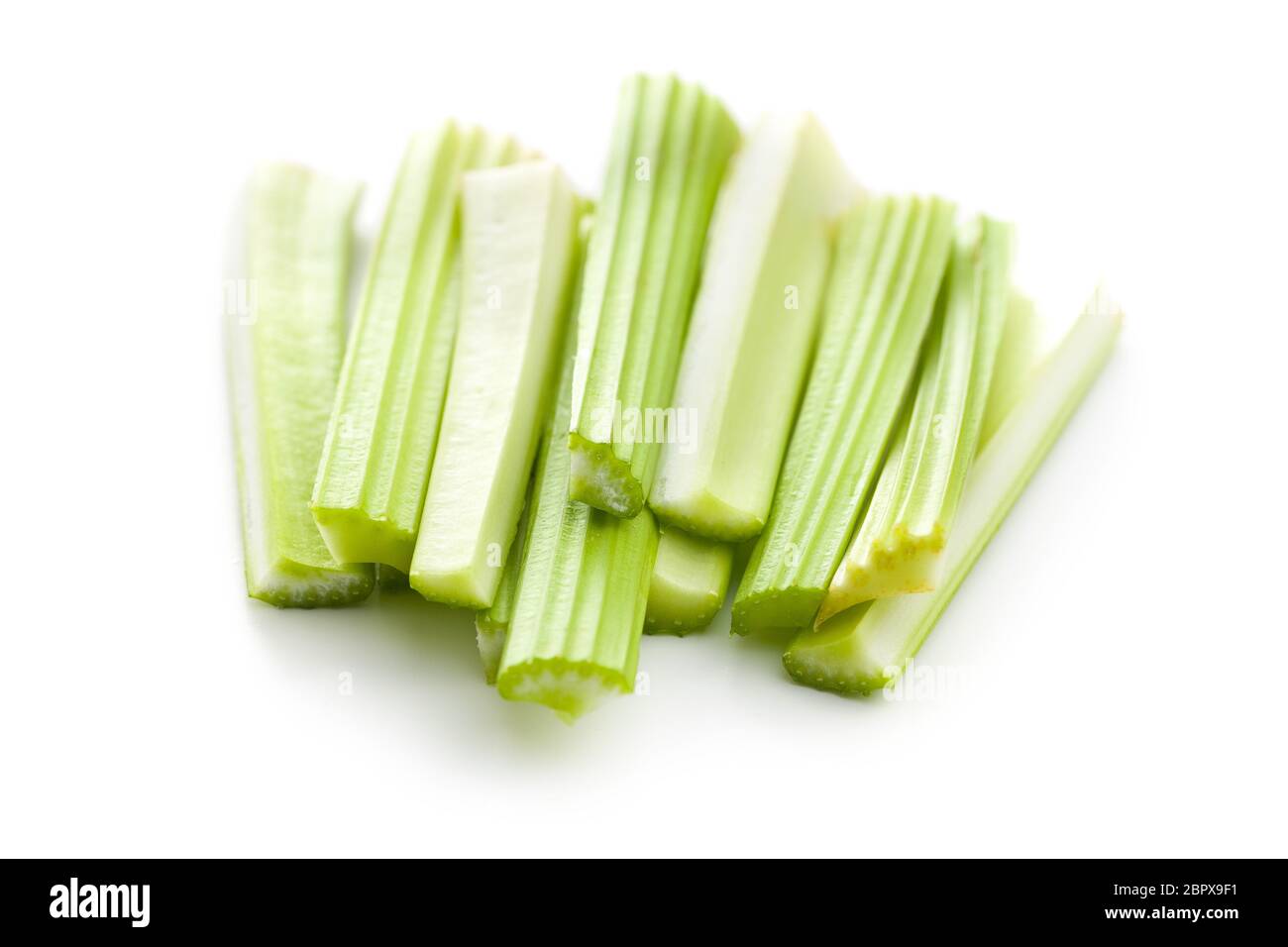 Celery sticks. Cutting celery stalks isolated on white background. Stock Photo