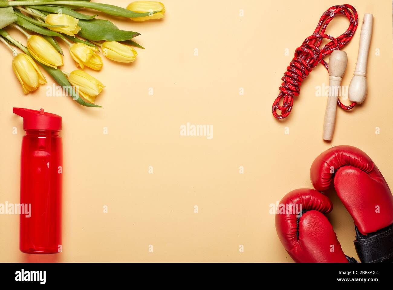 Female spring fitness. Sport accessories with boxing gloves, tulips