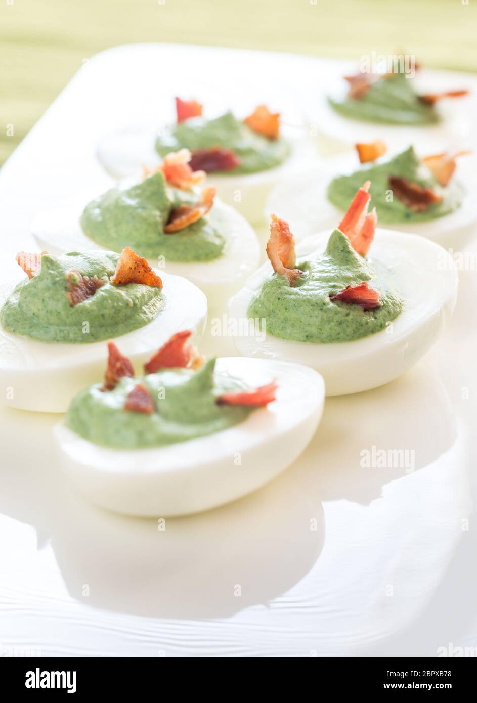 Spinach and bacon deviled eggs Stock Photo