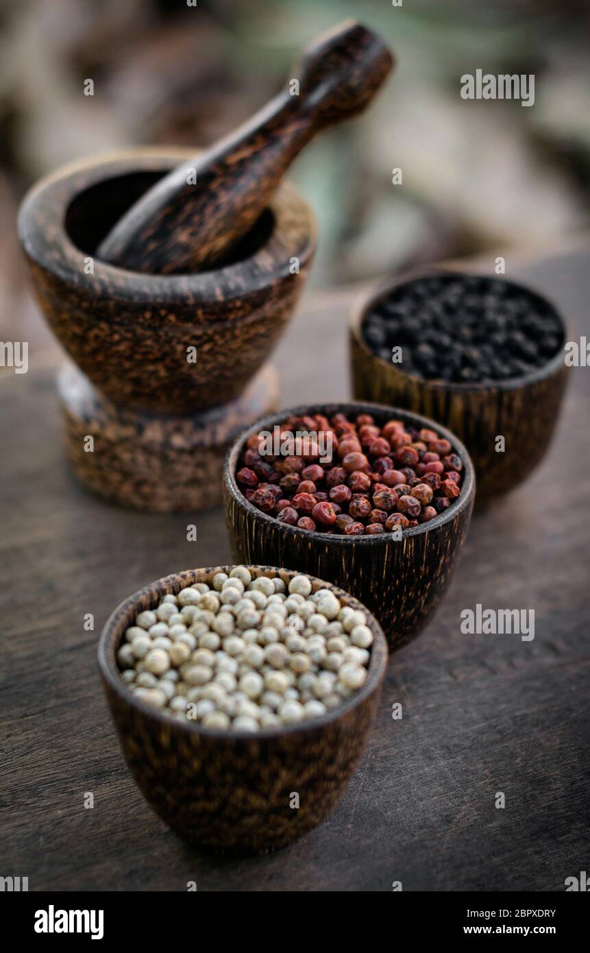 Organic kampot white red and black pepper corns in natural rustic style