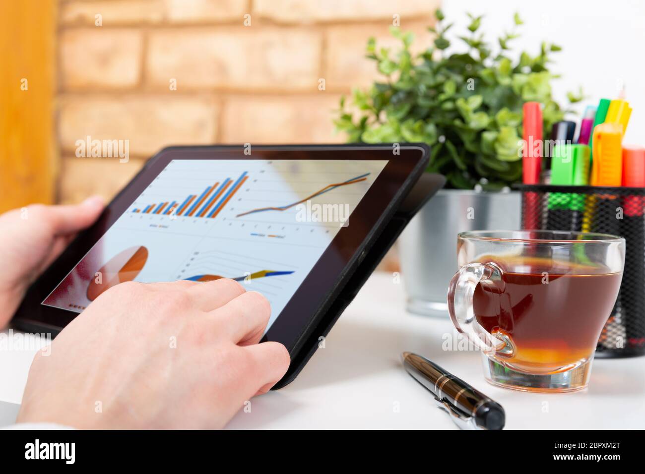 Data analysis concept shown on a tablet held by a woman Stock Photo