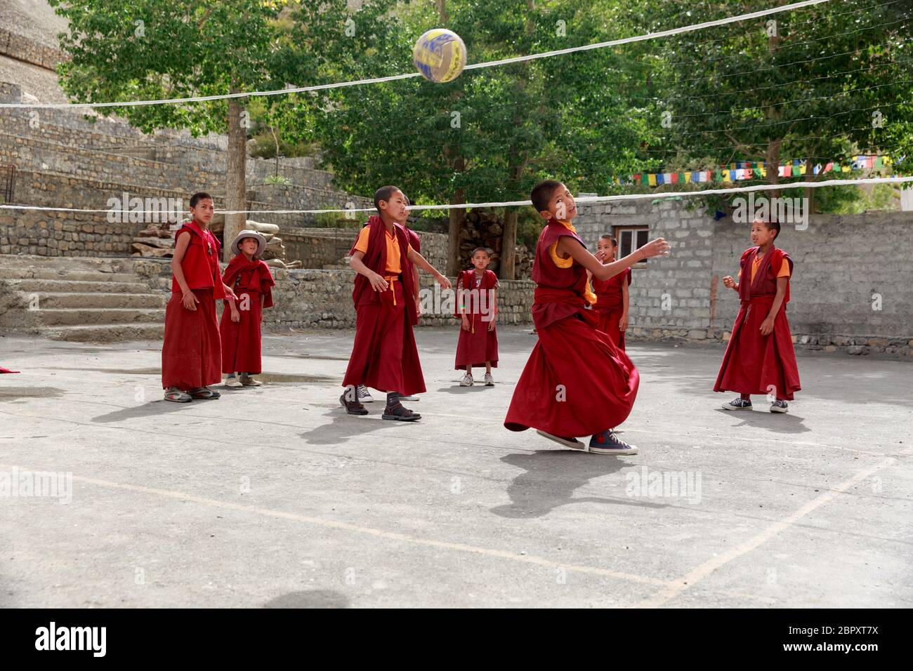 Buddhist children monks playing volley ball outside Ki monastery, Himachal Pradesh, India Stock Photo
