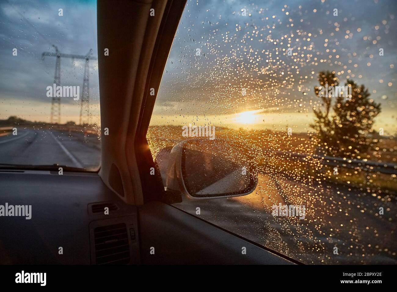 Driving a car in rain, interior view from passenger seat Stock Photo