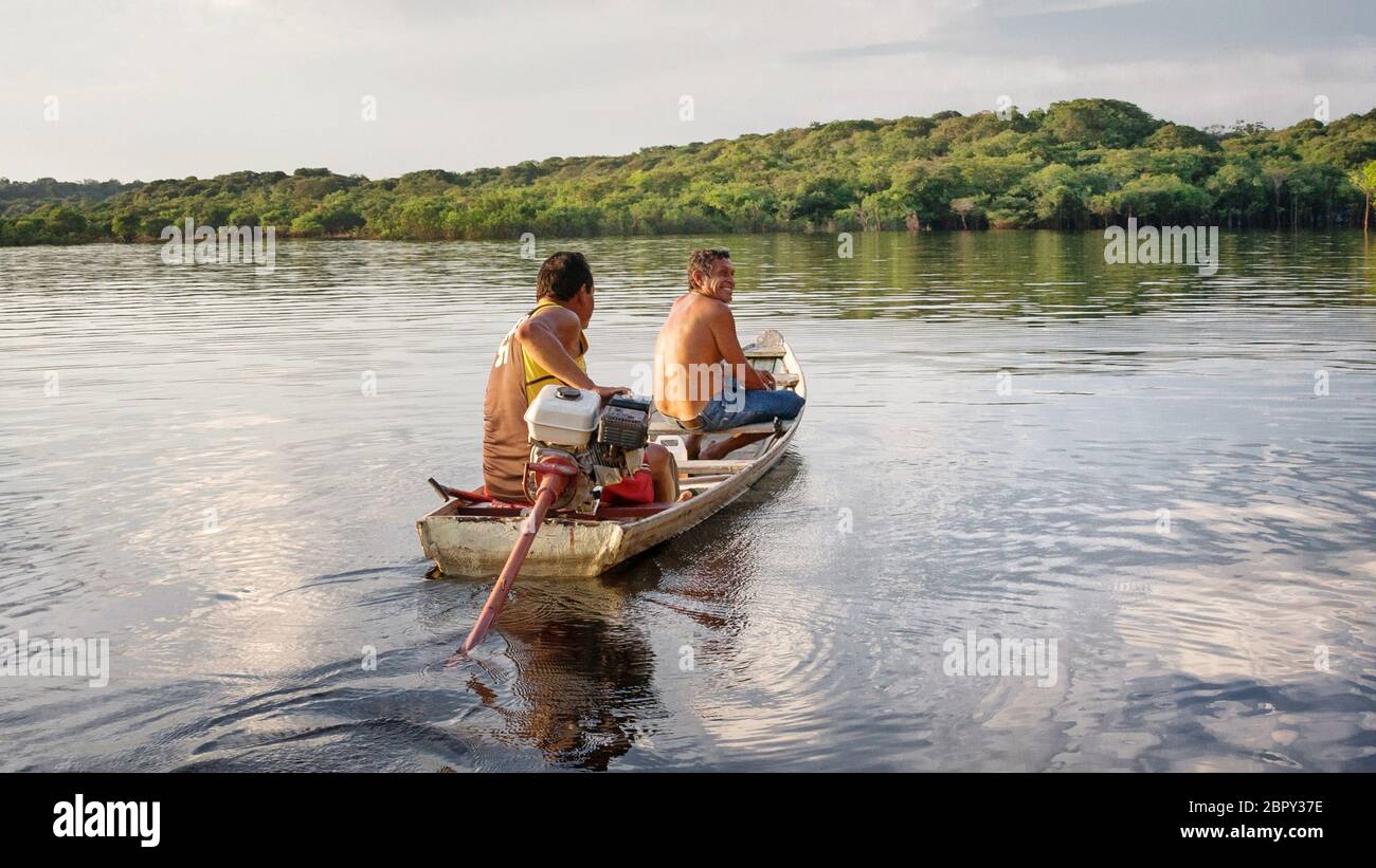 Two friends in a small fishing boat on a lake Stock Photo - Alamy