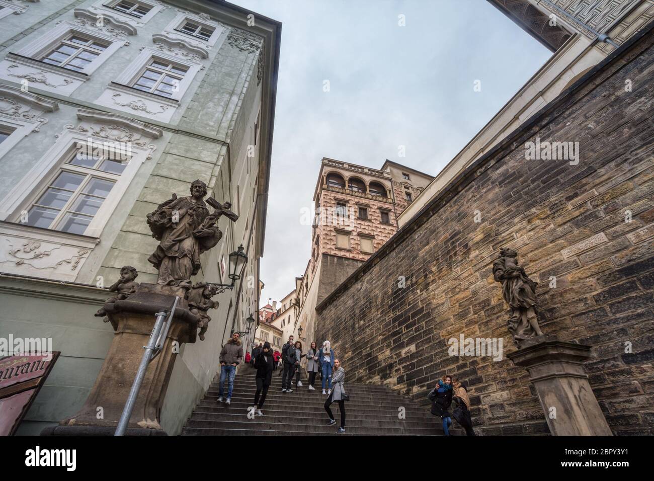 PRAGUE, CZECHIA - NOVEMBER 2, 2019: Tourists climbing the old castle stairs, also called stare zemecke schody, near the Prague Castle, or Prazsky Hrad Stock Photo