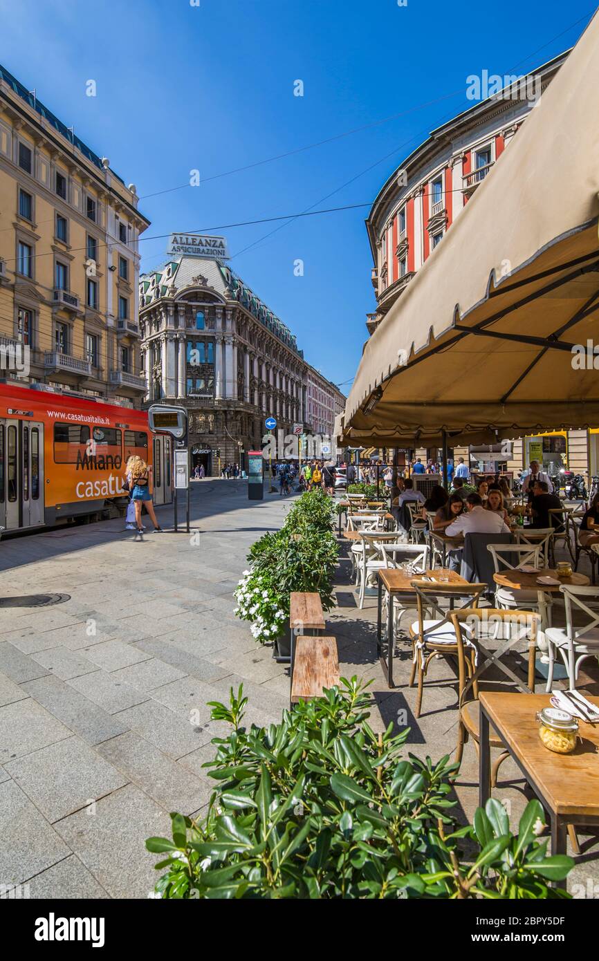 View of restaurant, tram and pedestrians on Via Dante, Milan, Lombardy, Italy, Europe Stock Photo