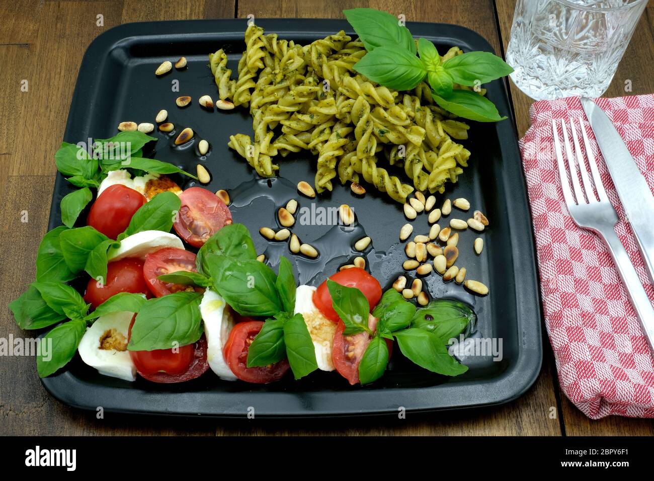Caprese Salad with Eliche Pasta in a Basil Pesto Sauce Stock Photo