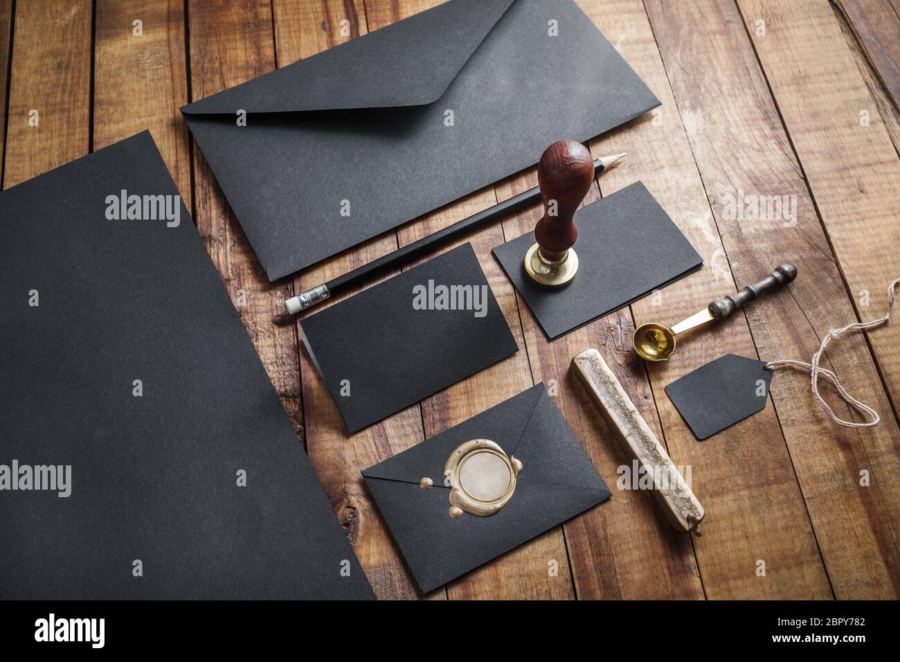 Blank retro stationery on vintage wood table background. Mockup for your design. Stock Photo