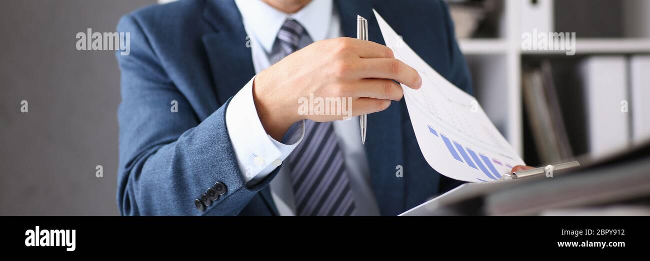 Serious businessman in the office examines documents Stock Photo