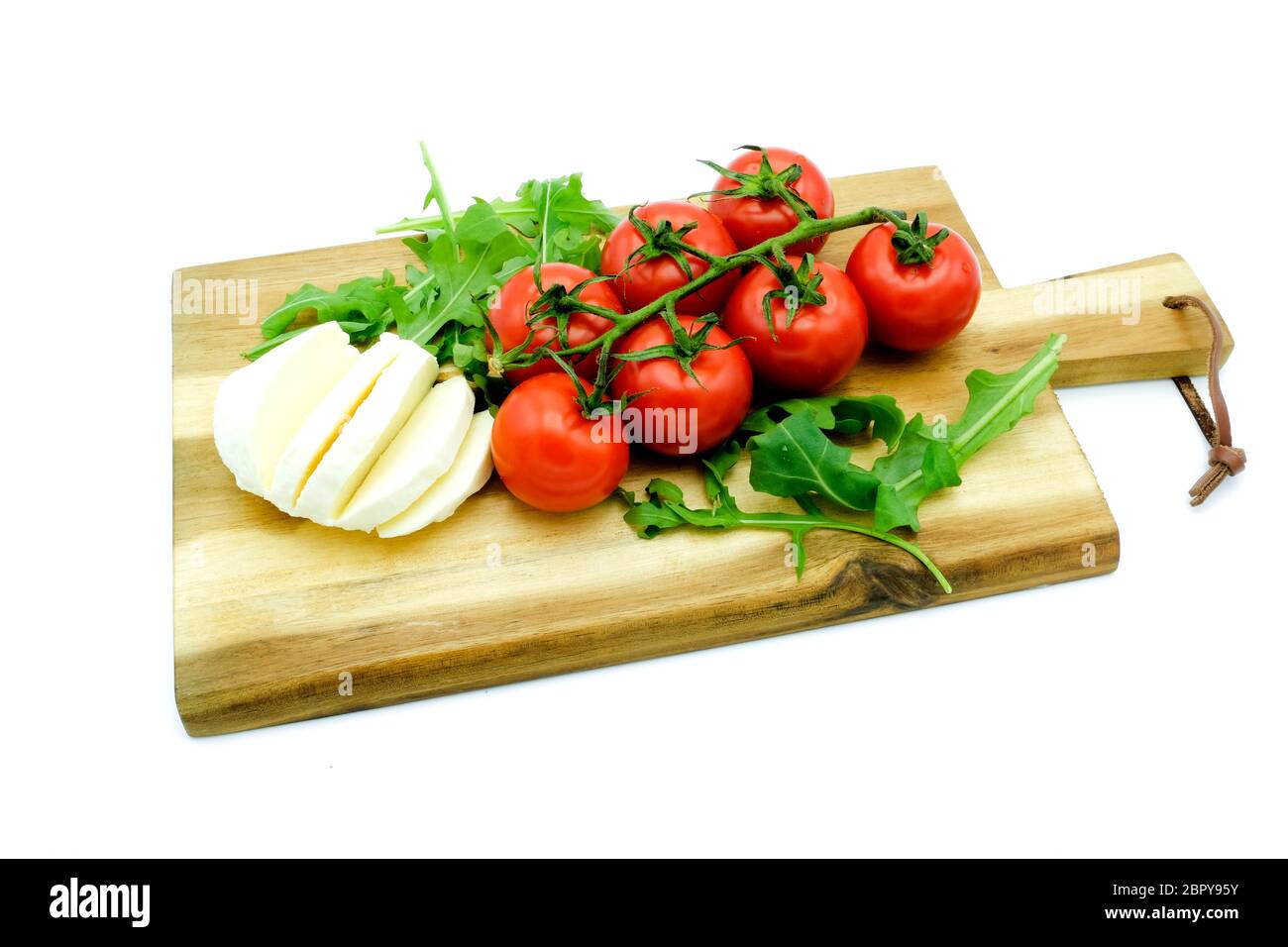 Wooden Board with Mozzarella, Tomatoes and Rucola Stock Photo