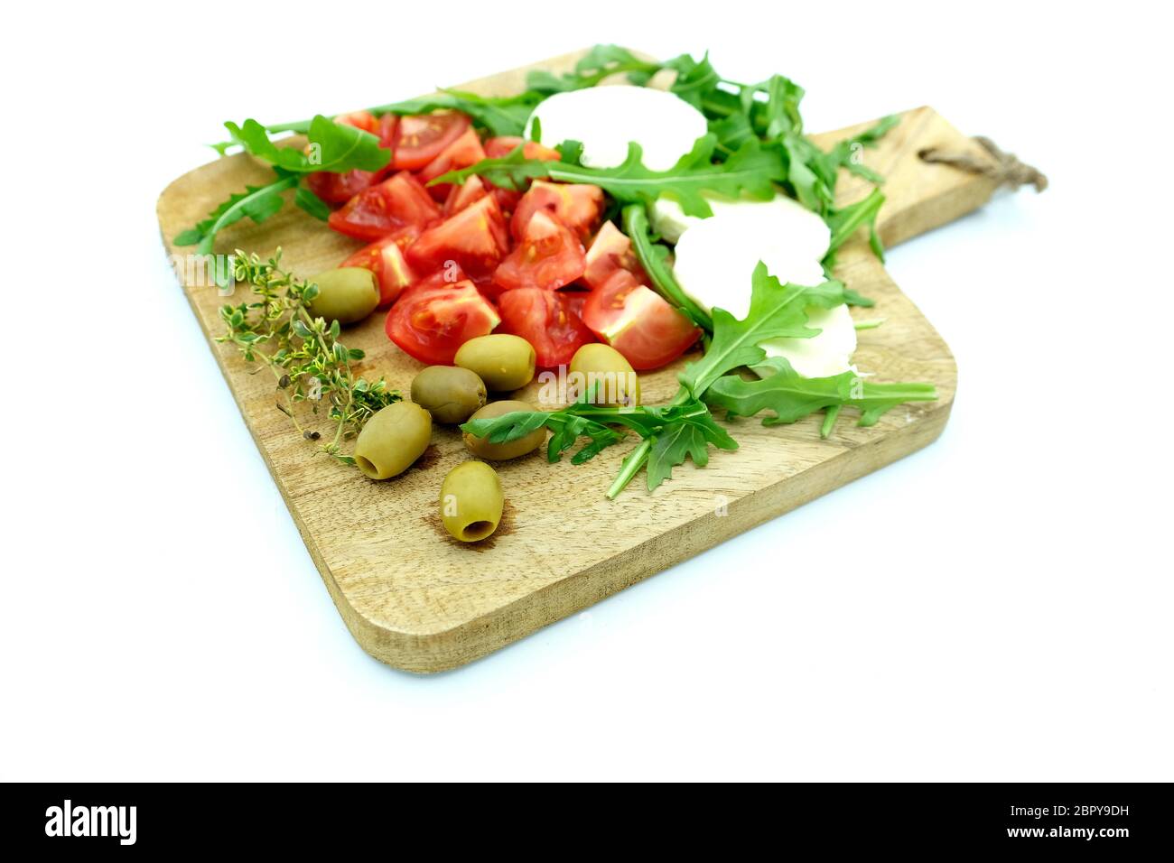 Wooden Board With Tomatoes, olives, mozzarella and rucola Stock Photo