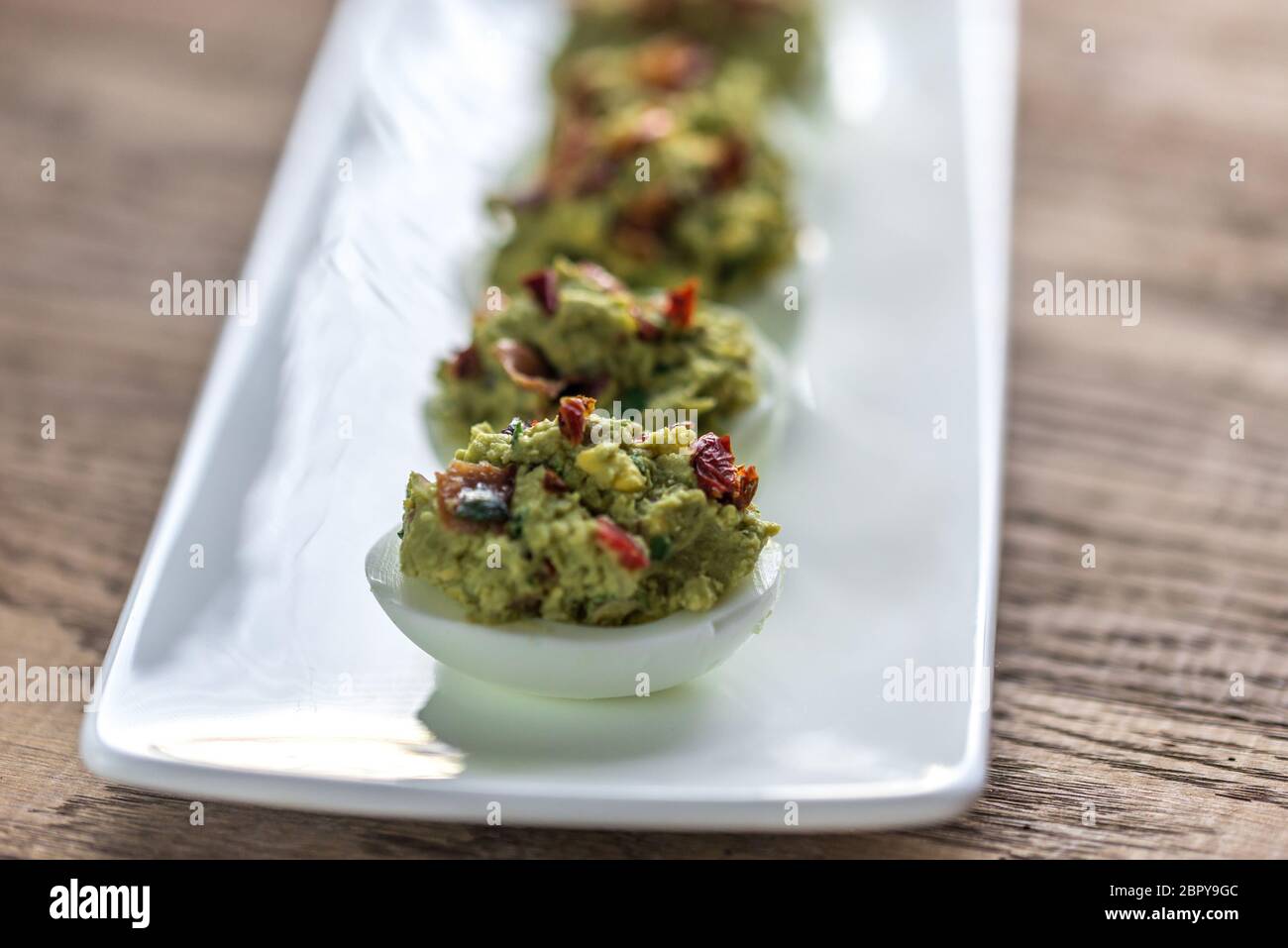 Bacon guacamole deviled eggs Stock Photo Alamy