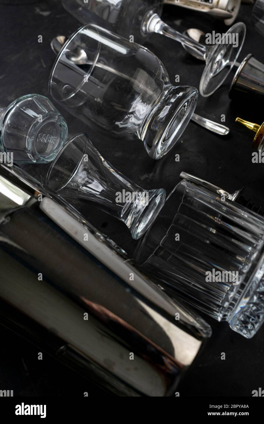 a set of bartending equipment with glass dishes, glasses and steel spoons Stock Photo