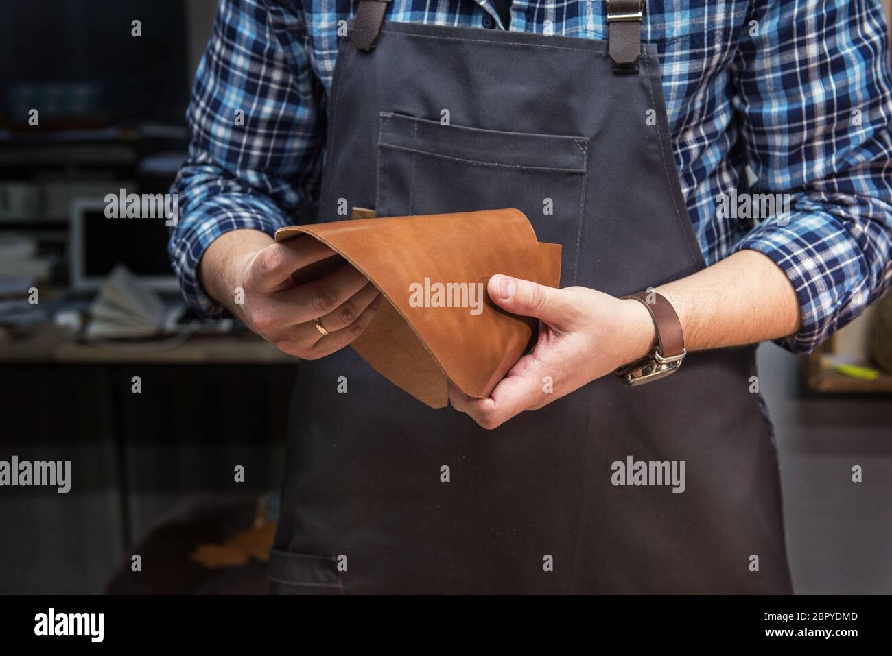 Man holding leather textile at a Concept of handmade craft