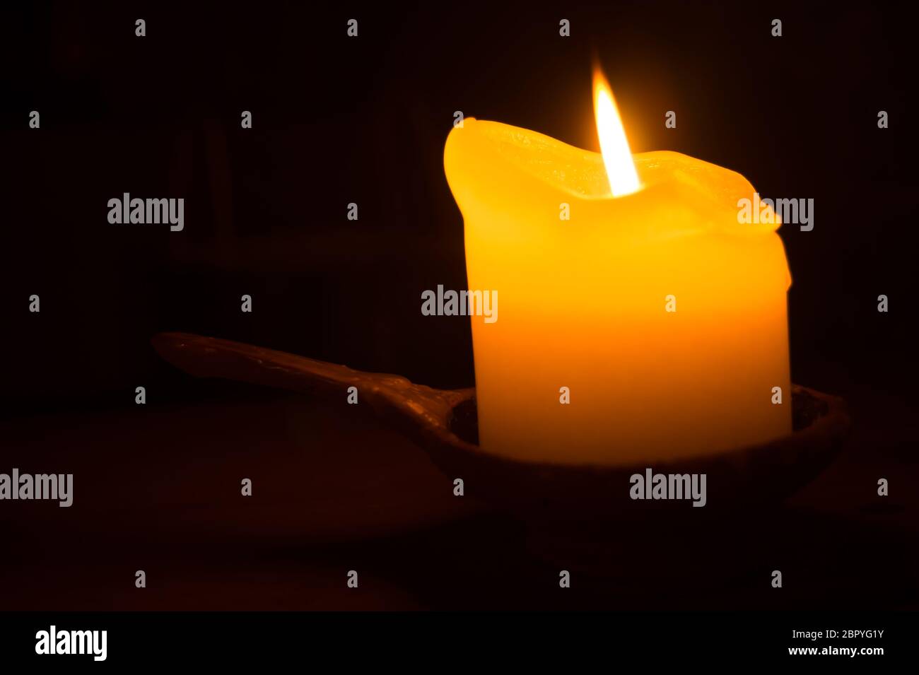 Burning candle in the dark Stock Photo Alamy
