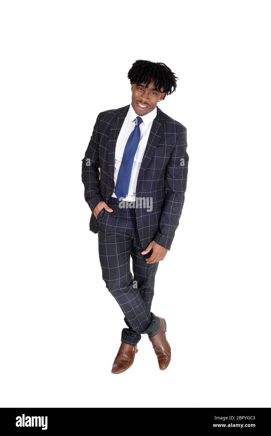 An African American young man standing in a suit and white shirt and ...