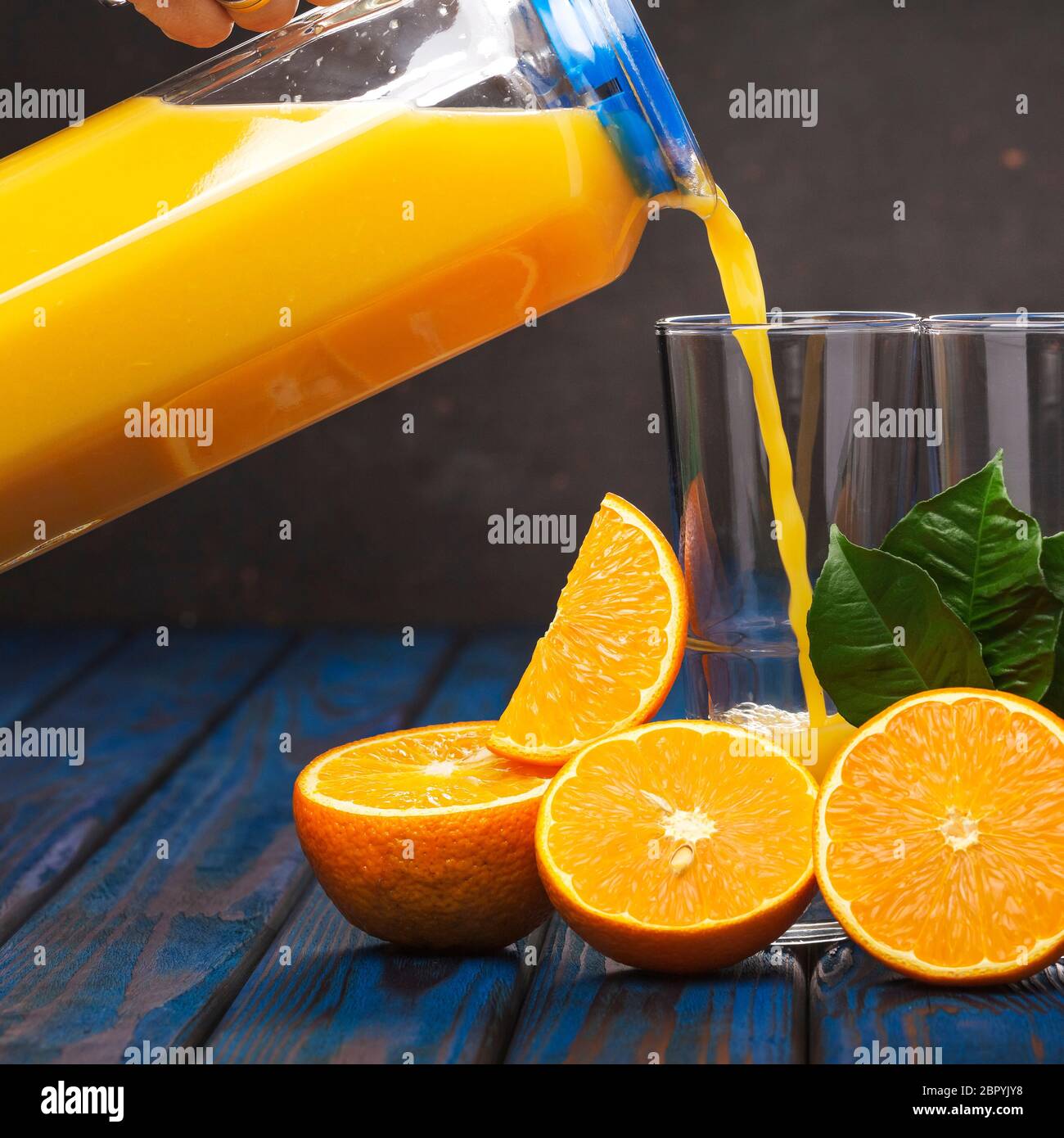Pouring orange juice. Freshly squeezed orange juice. Healthy eating