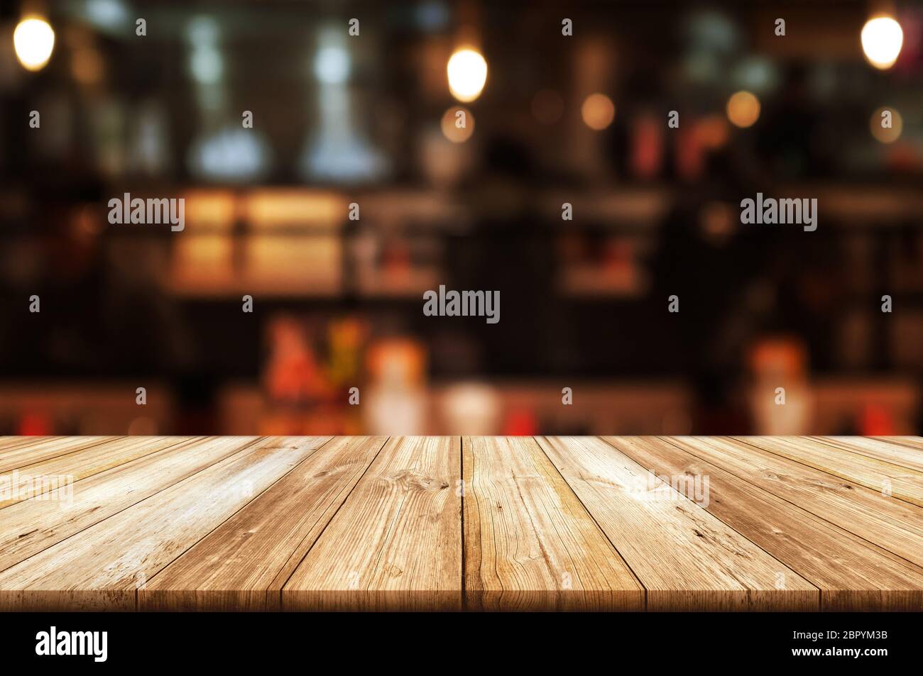 Empty wooden table top with blurred coffee shop or restaurant interior  background. Abstract background can be used for display or montage your  product Stock Photo - Alamy