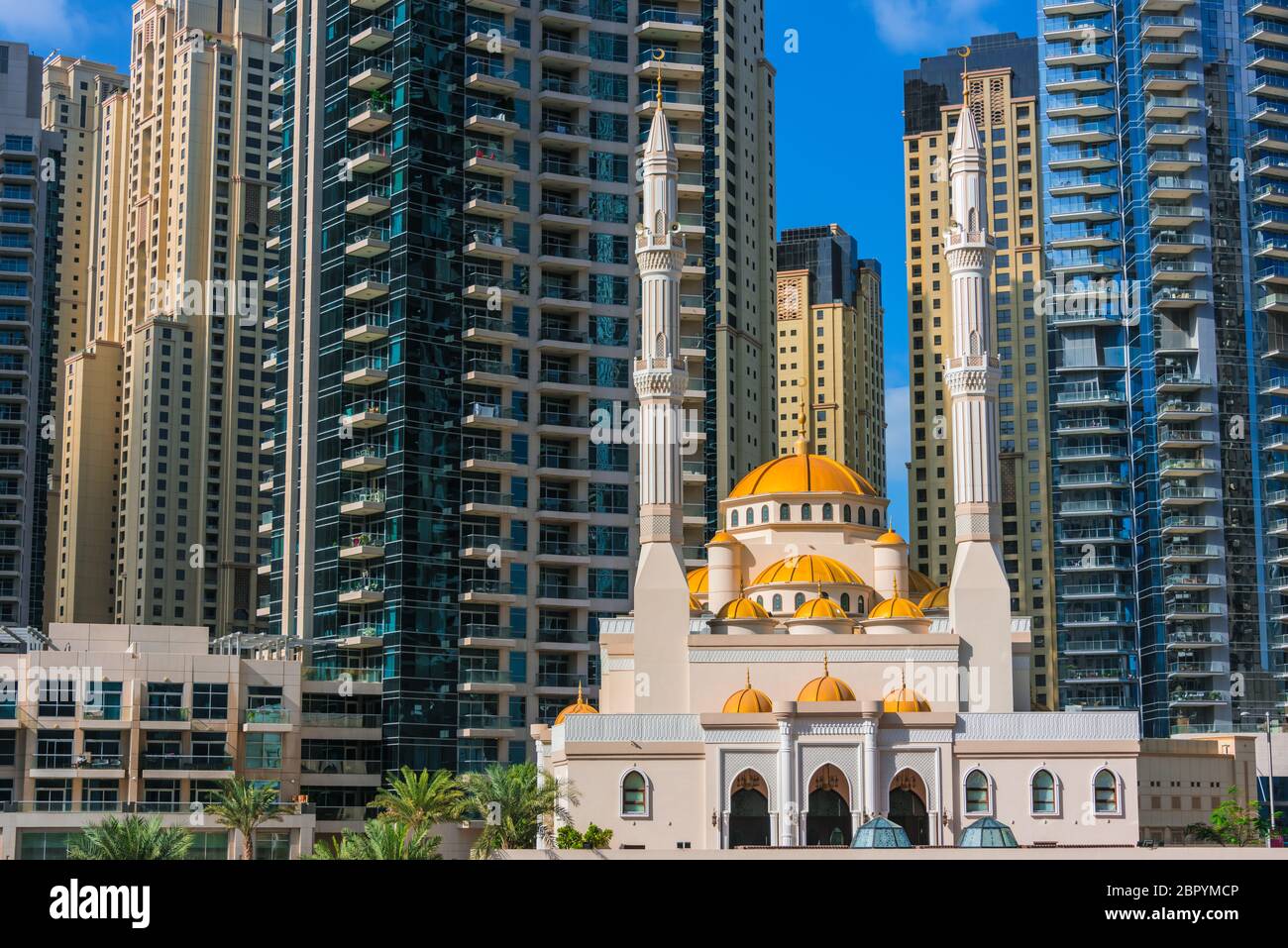 Modern residential architecture of Dubai Marina and Mohammed Bin Ahmed Almulla Mosque, United Arab Emirates. Stock Photo