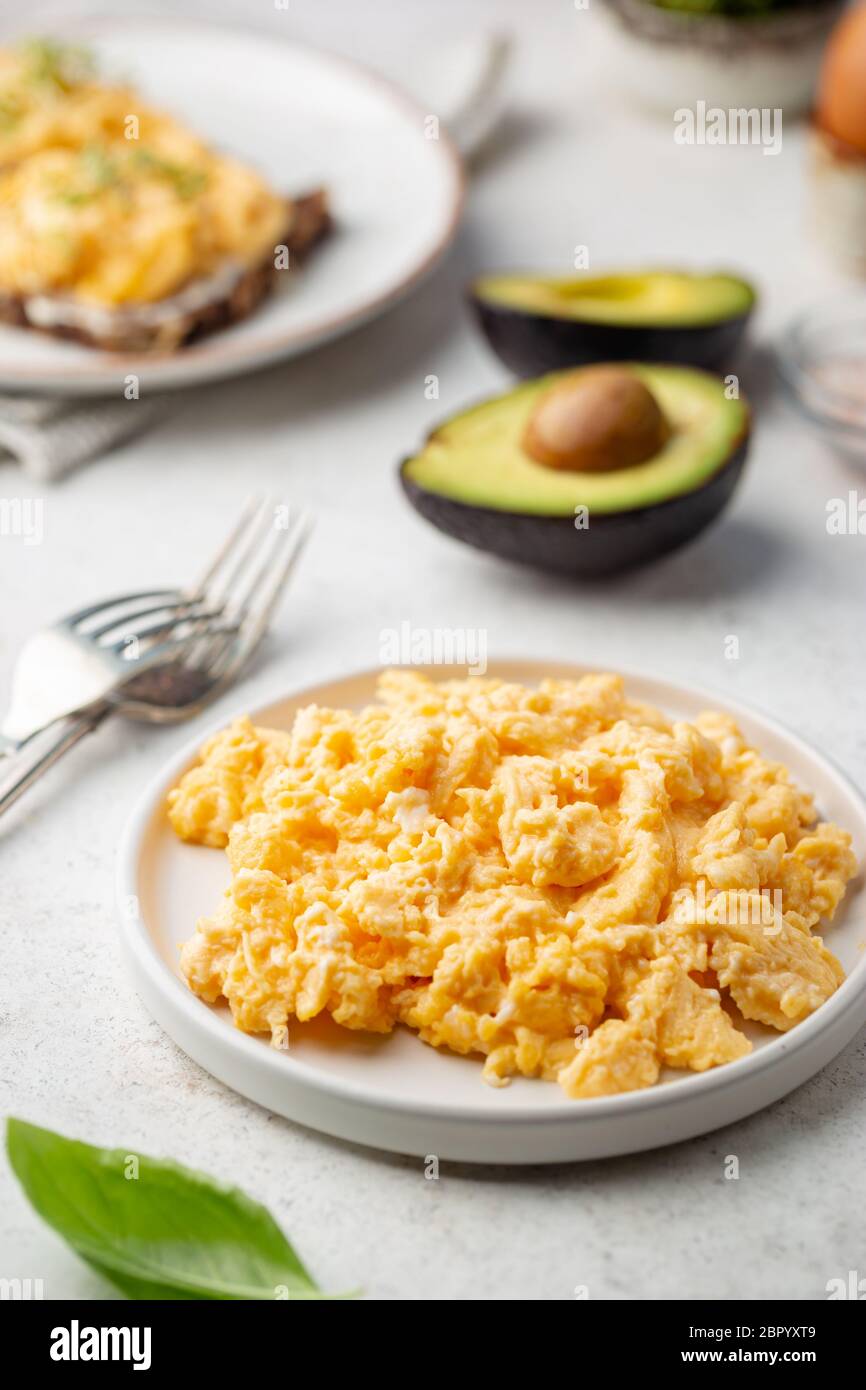 Fresh cooked scrambled eggs in a plate on white background Stock Photo ...