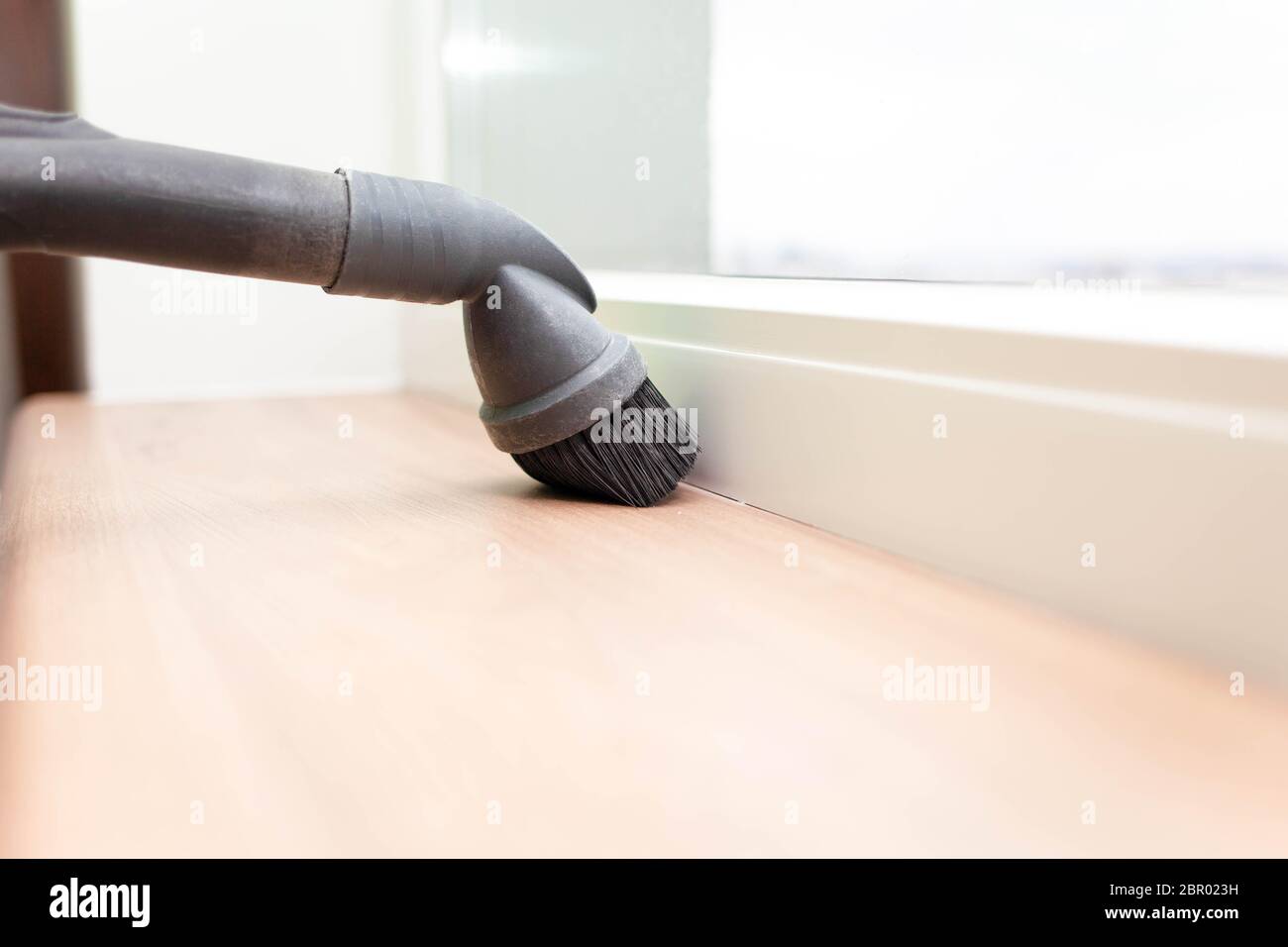 close up of woman's hand cleaning couch using vacuum cleaner at home window Stock Photo Alamy