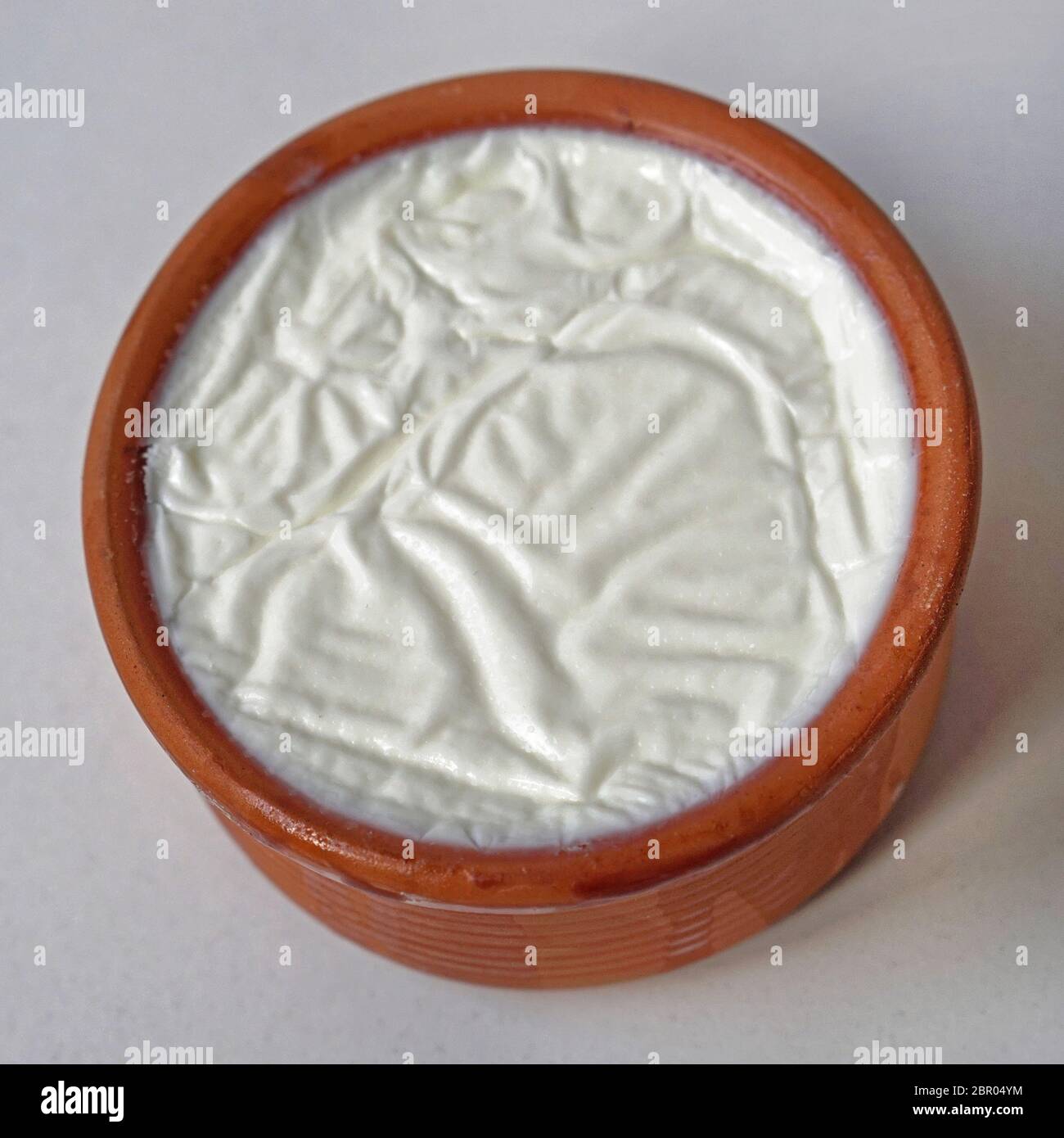 Greek style yogurt in terracotta pot Stock Photo Alamy