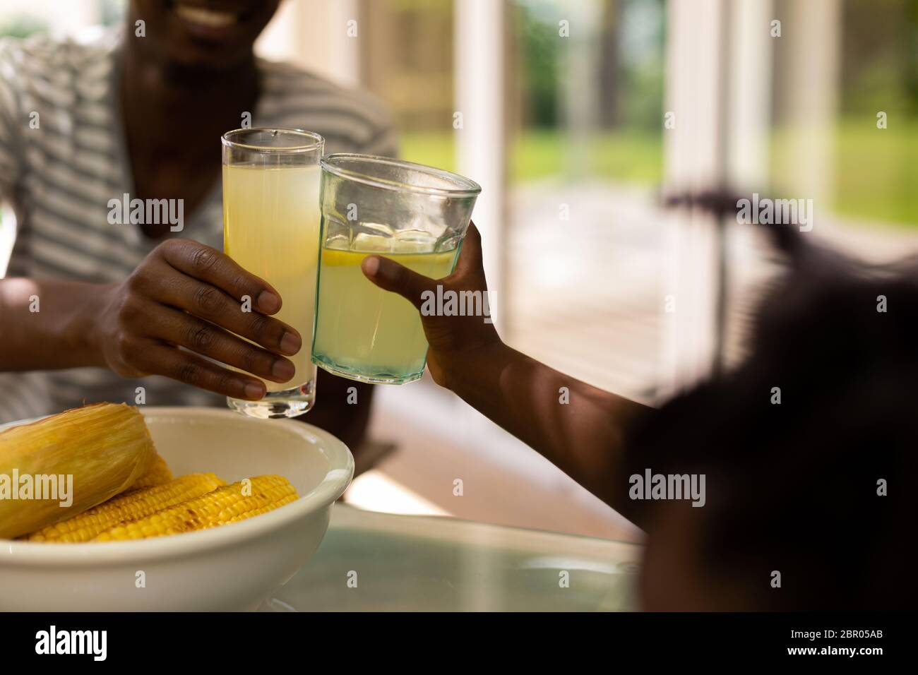 Family eating together at table Stock Photo