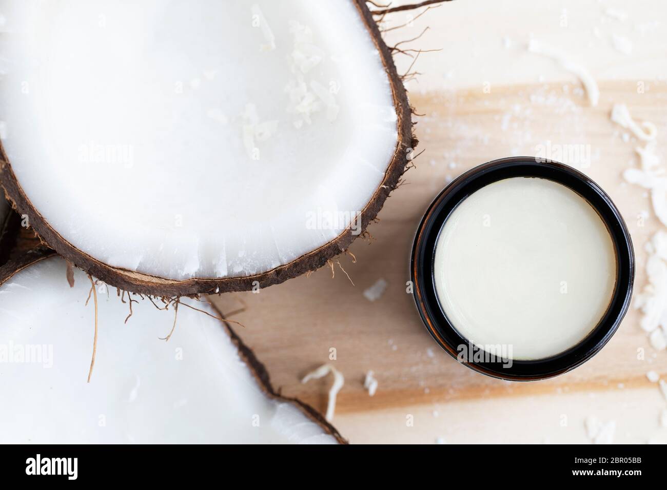 Coconuts with coconut cosmetic cream from a top down view. Stock Photo