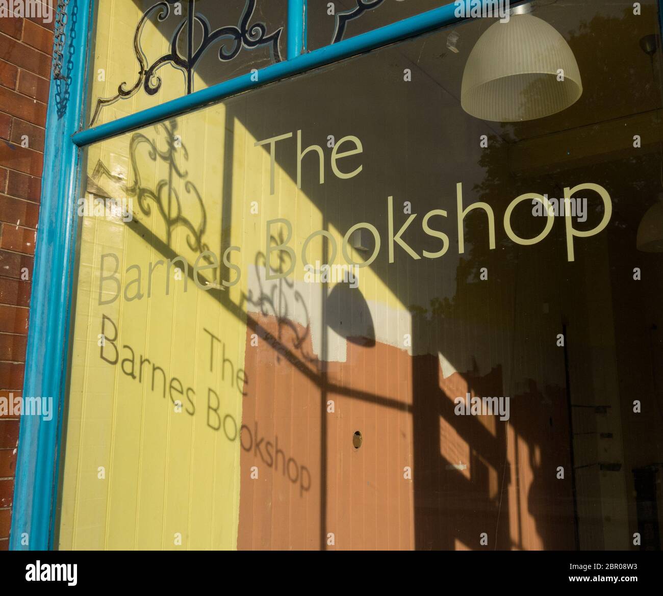 Shadows in the window of the former and now empty Barnes Bookshop, Barnes, London, SW13, UK Stock Photo