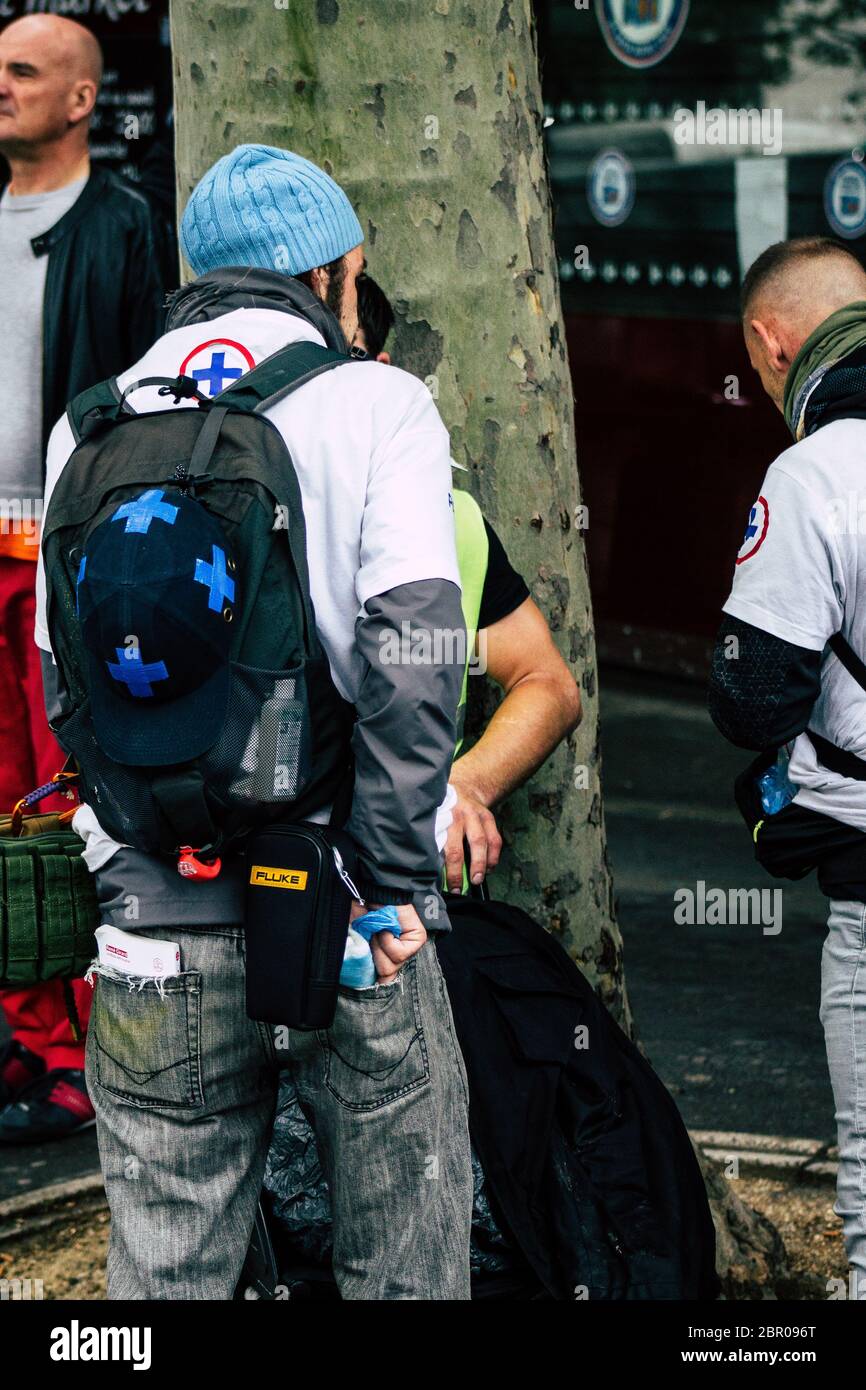 Paris France May 04, 2019 View of French street medic helping a protester injured by the riot squad of the French National Police in the street during Stock Photo