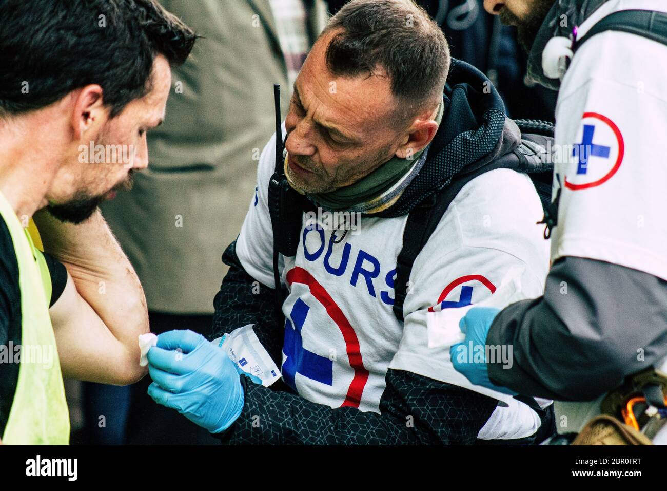 Paris France May 04, 2019 View of French street medic helping a protester injured by the riot squad of the French National Police in the street during Stock Photo