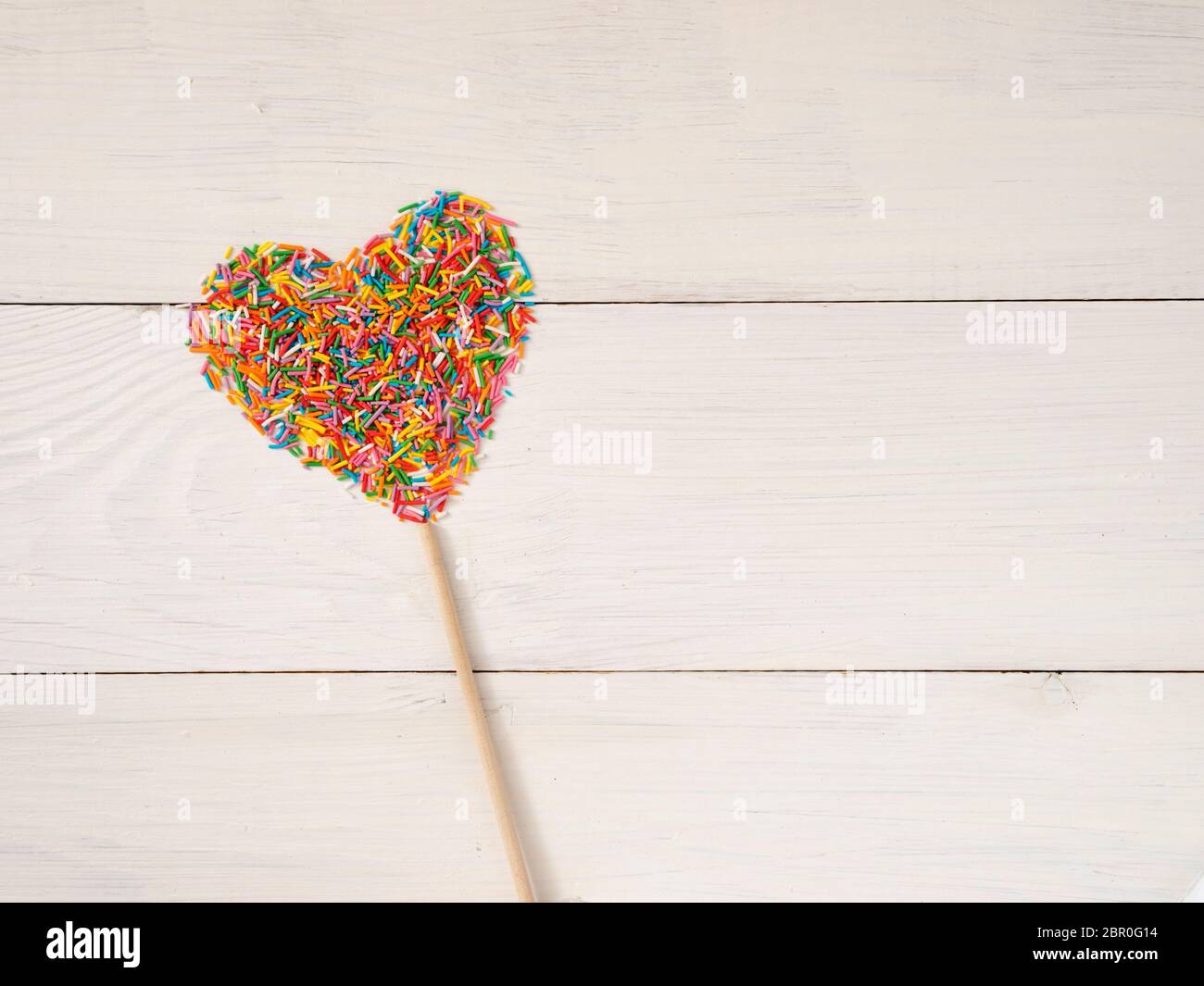 Candy sprinkles form heart shape. Multicolored heart-shape from candy