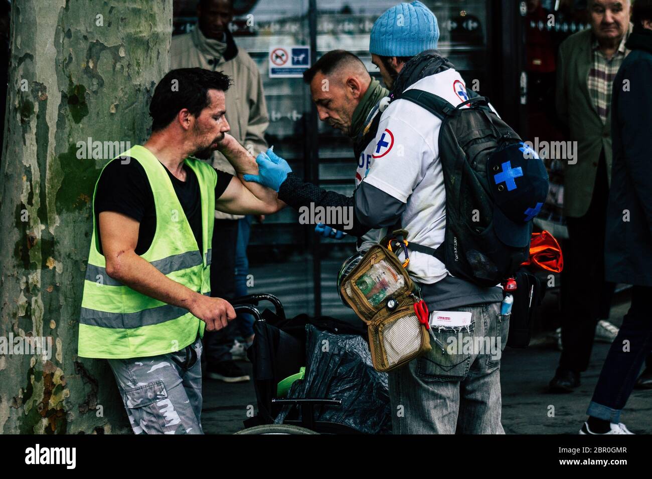 Paris France May 04, 2019 View of French street medic helping a protester injured by the riot squad of the French National Police in the street during Stock Photo