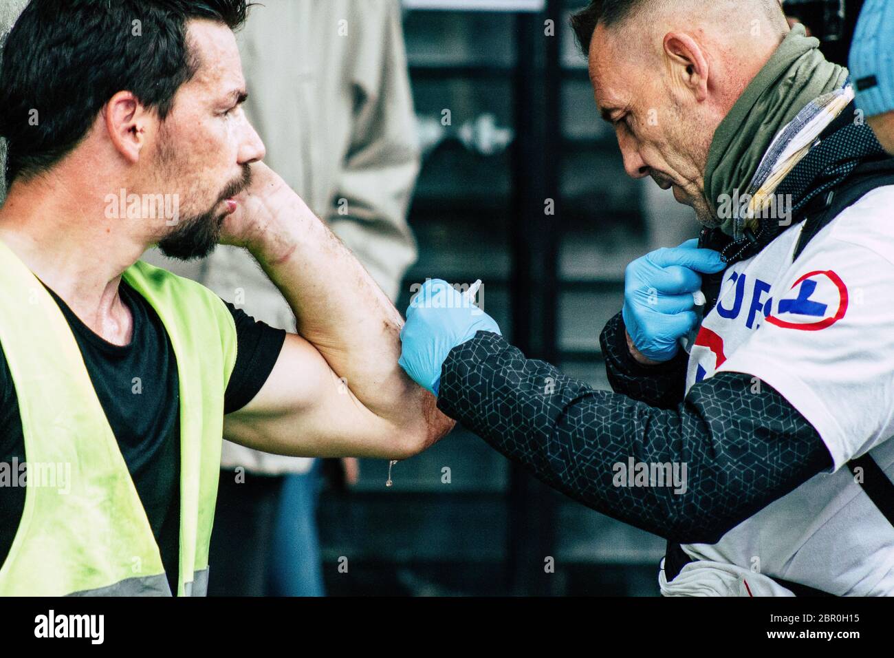 Paris France May 04, 2019 View of French street medic helping a protester injured by the riot squad of the French National Police in the street during Stock Photo