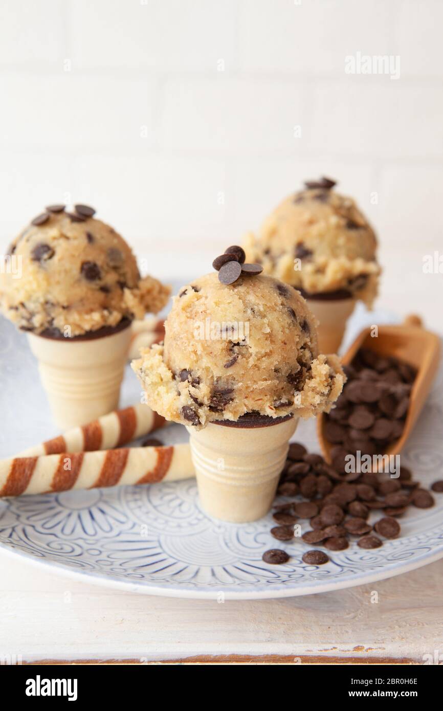 Edible cookie dough with chocolate chips and waffle rolls Stock Photo