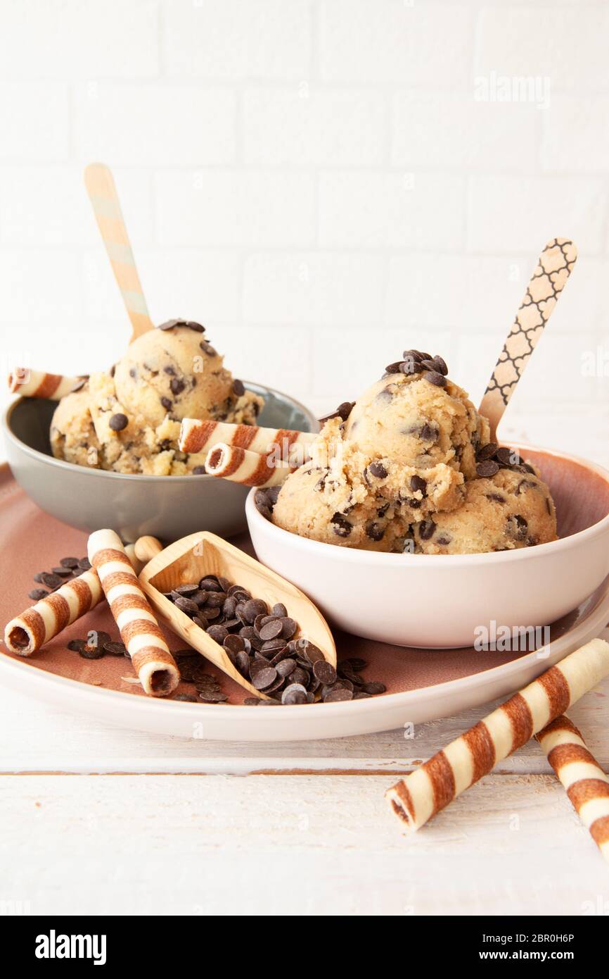Edible cookie dough with chocolate chips and waffle rolls Stock Photo