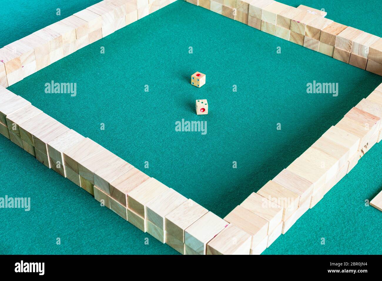 starting position of mahjong, tile-based chinese strategy board game on green baize table Stock Photo