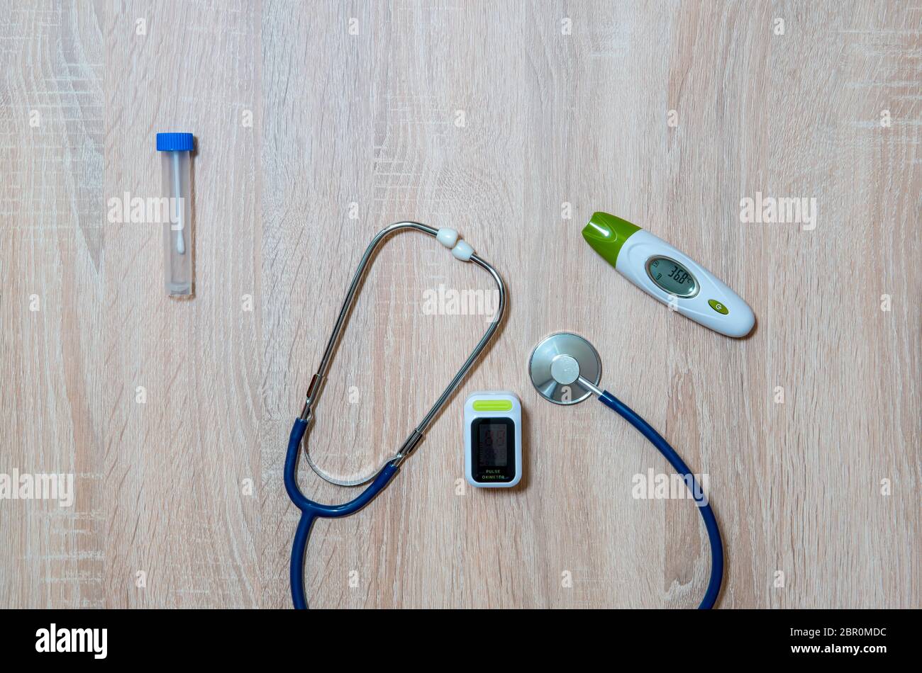 Doctor's equipment for taking tests for infection with the virus Covid-19-stethoscope, thermometer, oximeter and test tube Stock Photo