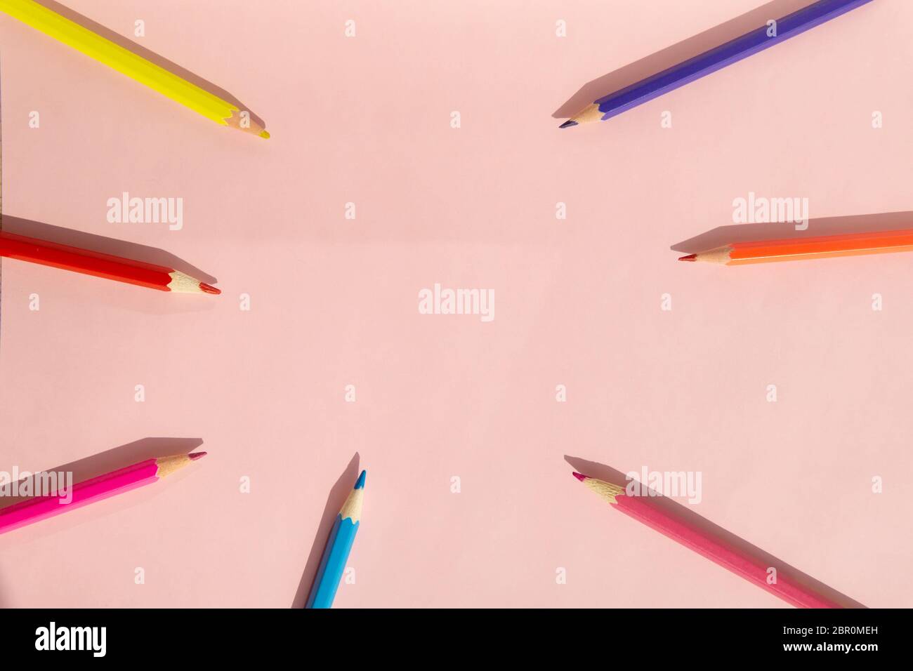 Background of colorful pencils on pink background. Back to school