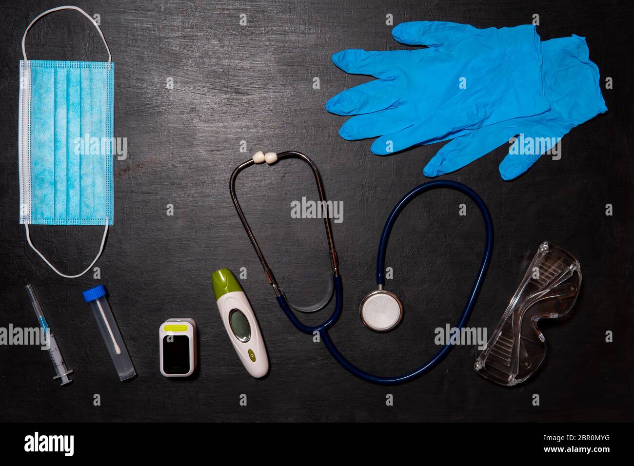 Doctor's equipment for taking tests for infection with the virus Covid-19-stethoscope, thermometer, oximeter, test tube, medical mask and disposable g Stock Photo