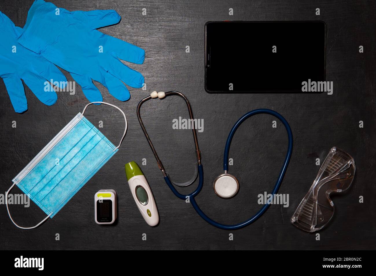 Doctor's equipment for taking tests for infection with the virus Covid-19-stethoscope, thermometer, oximeter, safety goggles, medical mask, disposable Stock Photo