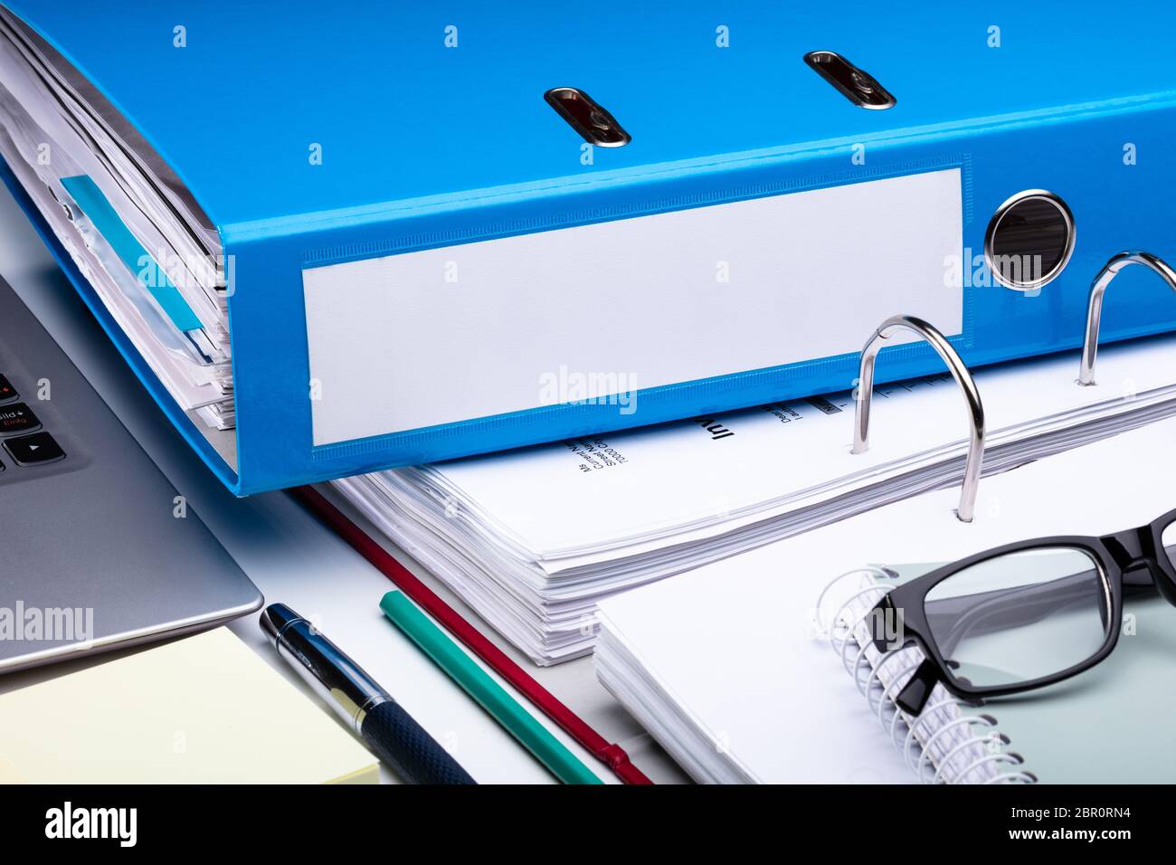 Office Workplace With Laptop And Folders On White Table Stock Photo