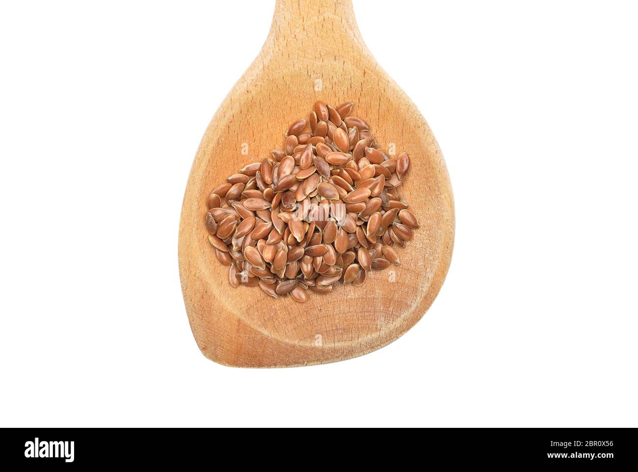 Linseed on wooden spoon and white background Stock Photo