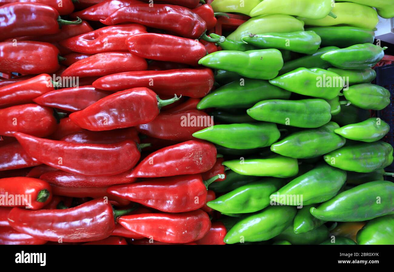 Red and green peppers on a farmer market. Vegetables pattern. Stock Photo