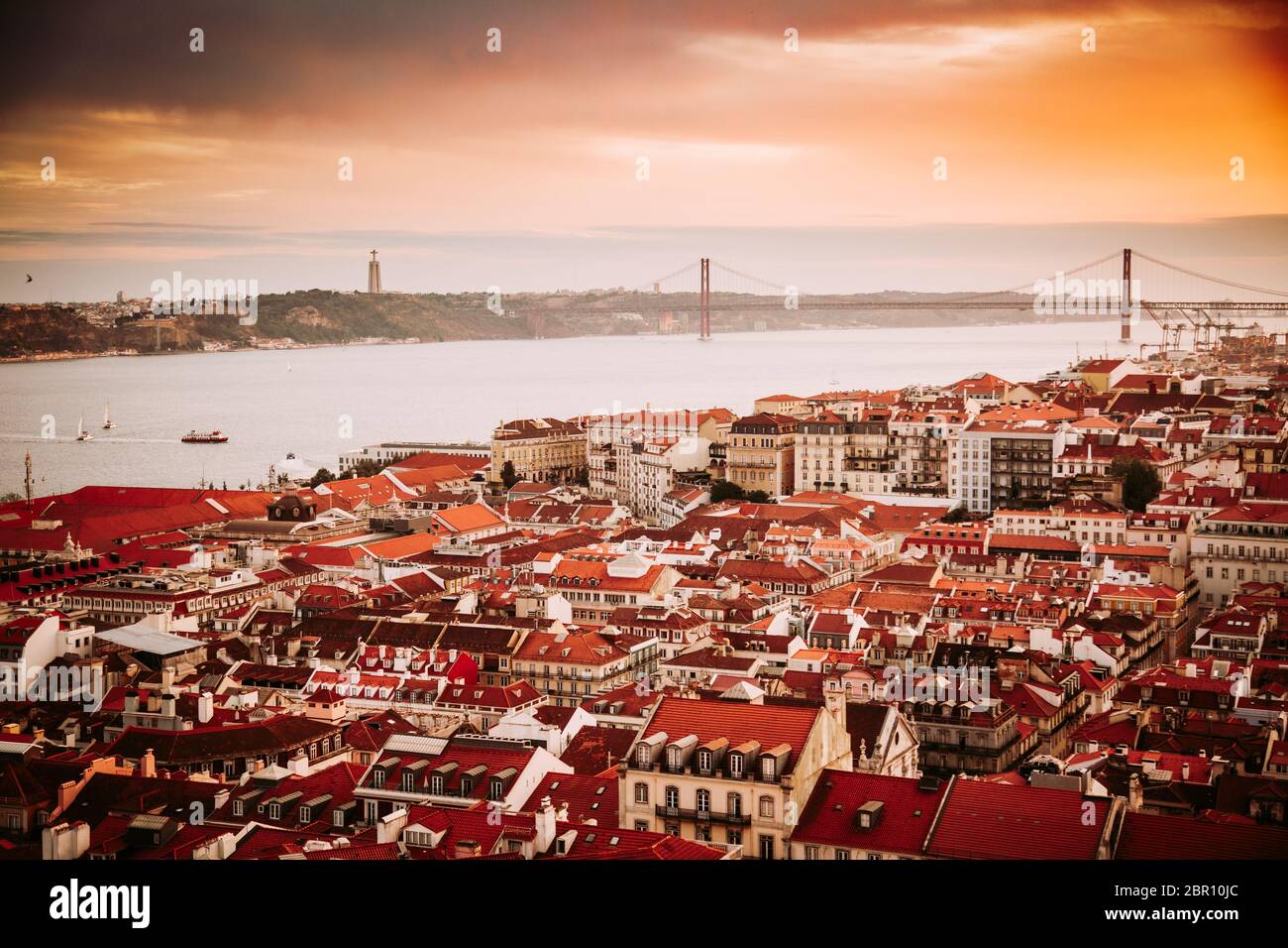 Beautiful panorama of old town Baixa district and Tagus River in Lisbon city during sunset, seen from Sao Jorge Castle hill, Portugal Stock Photo