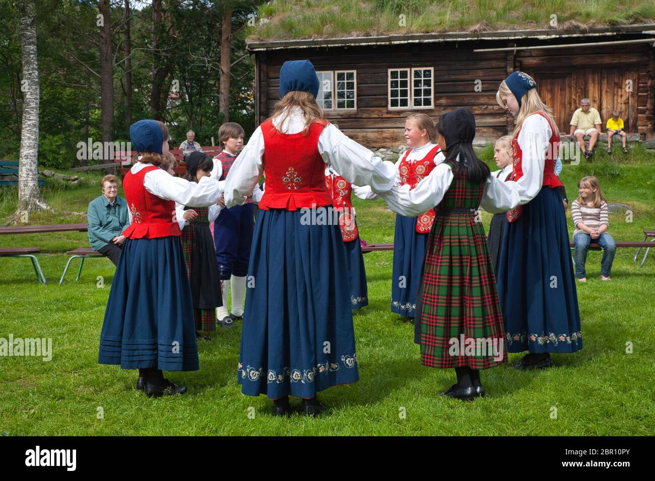 Traditional costumed dancers perform in a garden in Norway, Scandinavia Stock Photo
